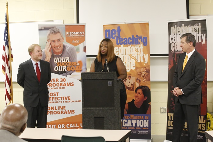 •	Erica Ways (2018 Graduate of PCC Associate Degree Nursing Program) speaking; Dr. Peter Hans, President of the North Carolina Community College System (left); Governor Cooper (right)