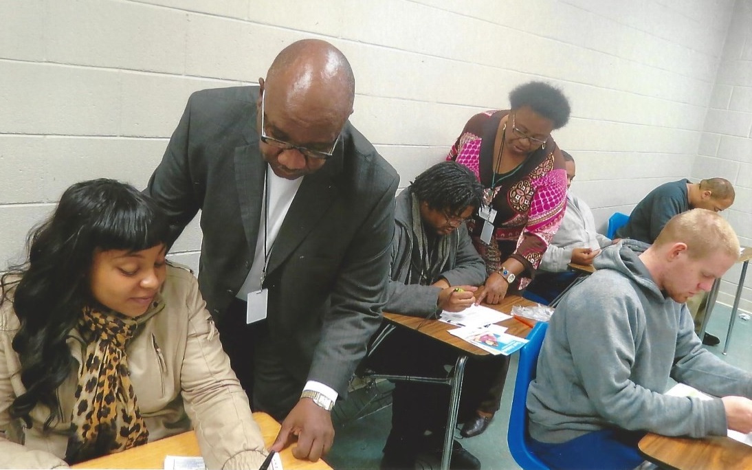 Dr. Alfred Faulkner and Mrs. Angela Bullock, Outreach Consultants with the Piedmont Community College’s Educational Opportunity Center, assisting participants with college financial aid applications at Kittrell Job Corps in Vance County.