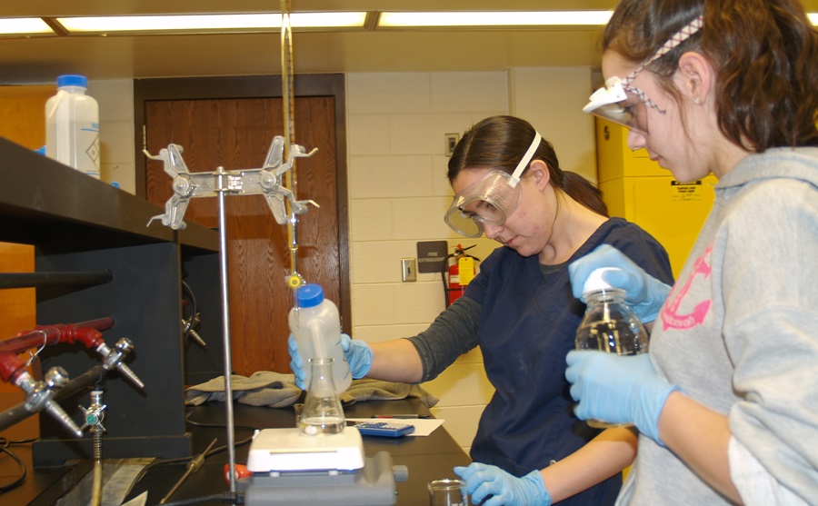 Jessica Horne working on experiment in a PCC Chemistry course with lab partner.