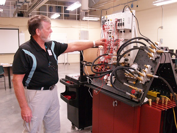 Instructor Mike Cobb with Siemens Level I Mechatronics equipment that will be used during the hands-on training at PCC.