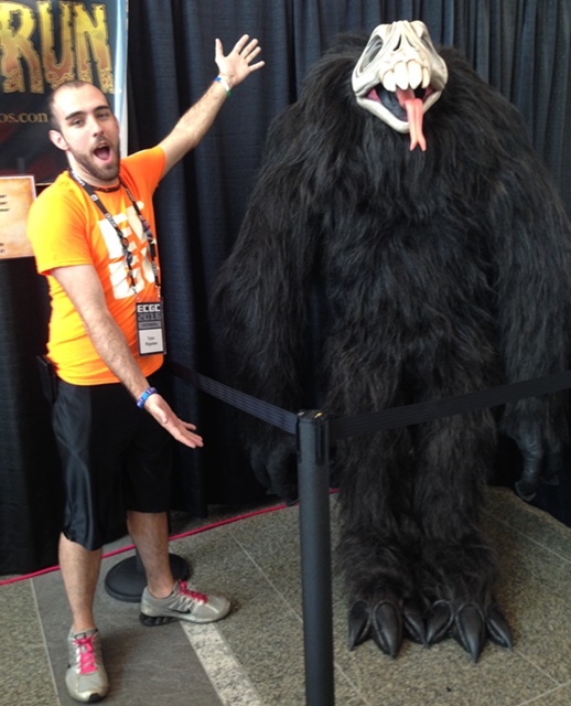 Tyler Riggsbee with a Temple Run 2 character at the Imangi Studios, Temple Run2 booth.